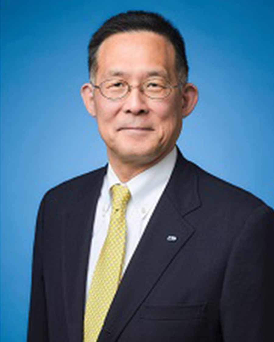 Yashuhiro Fujiwara against a blue background