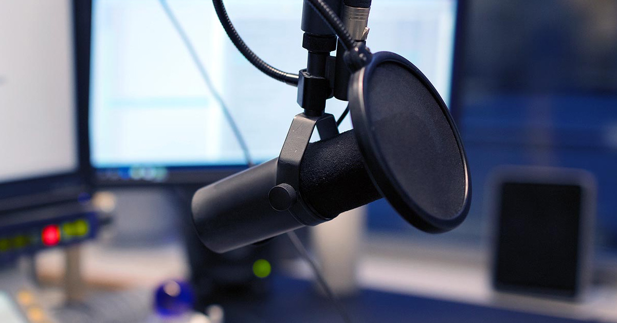 a podcast studio with the mic set up with a pop filter in front of it