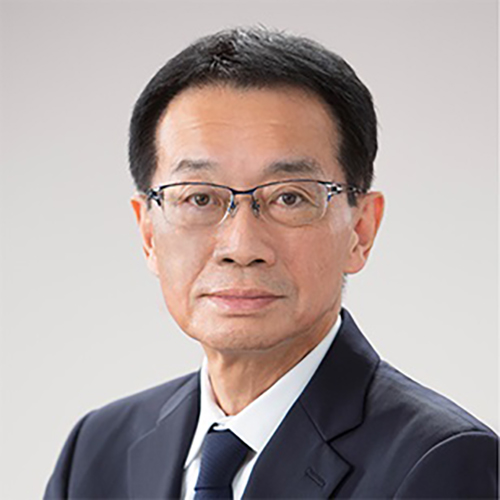 A portrait photograph headshot of new Senior Vice President and Managing Director (DIA Japan and Korea) Shogo Nakamori grinning in a dark navy blue business suit and tie