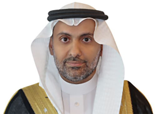 Portrait orientation headshot photograph of Fahad bin Abdulrahman AlJalajel grinning wearing traditional Saudi Arabian attire, which includes a white ghutra and black agal